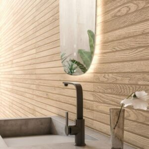 SEASON-CARAMEL-WOOD-EFFECT-CERAMIC-TILES. Image shows caramel wood effect ceramic tiles to a wall in bathroom with mirror, basin and taps