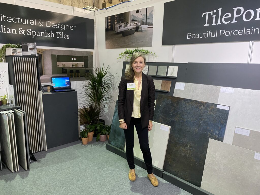 BICESTER-EXHIBITION. Image shows lady on exhibition stand with laptop and tiles on stands