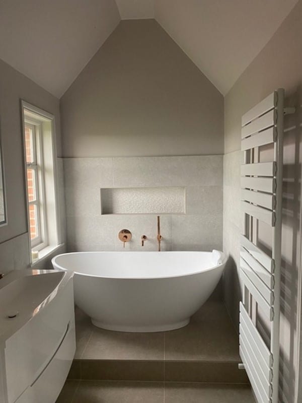 DOCKLANDS. Image shows bathroom with wall and floor tiles and bath and radiator and sink