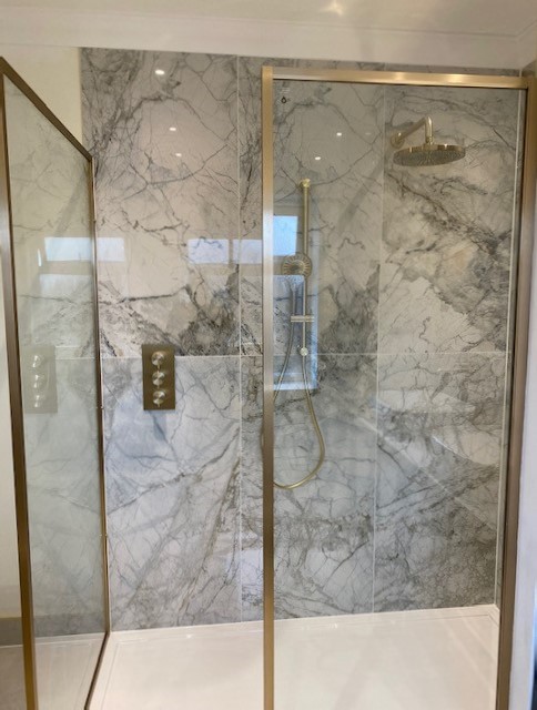 BELLEZA-WHITE. Image shows polished marble tiles in a shower