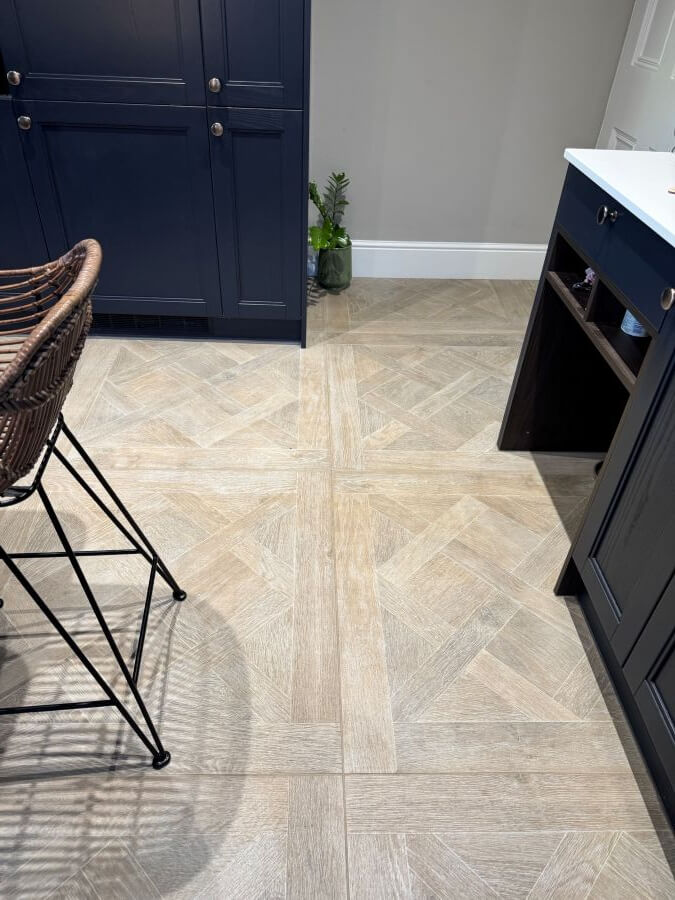 Louis porcelain floor tile that looks like wood, image shows marquetry wood effect floor tiles in the entrance to a kitchen.