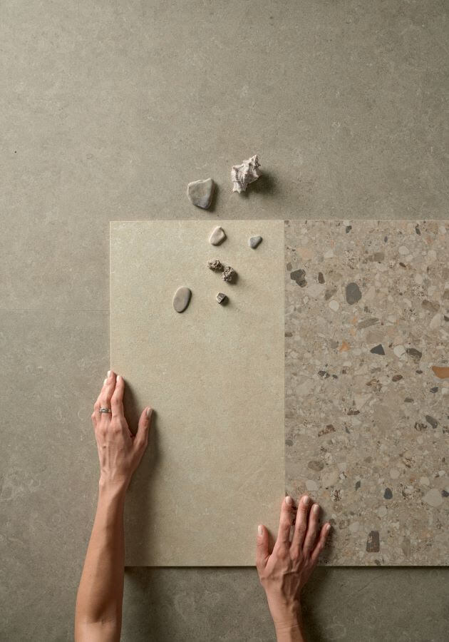 FUSION-STILL-LIFE. Image shows tiles with stones and a persons hands