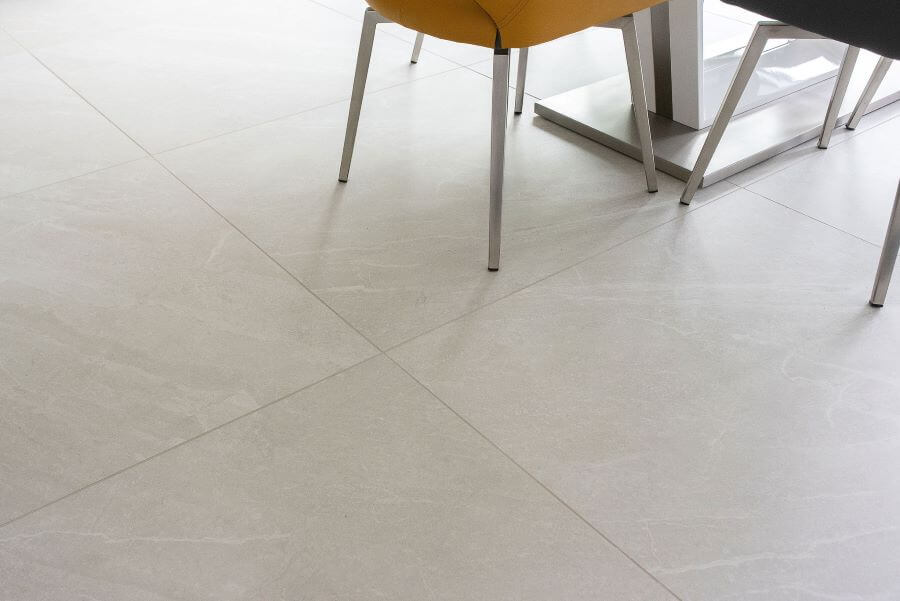 HAVEN-STONE-KITCHEN. Image shows large stone effect tiles on floor with chair legs