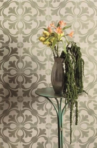 MODE_PATTERENED_CERAMIC_TILES_OLIVE_CLOSEUP. Image shows olive and cream patterned tile on wall with green vase in the foreground