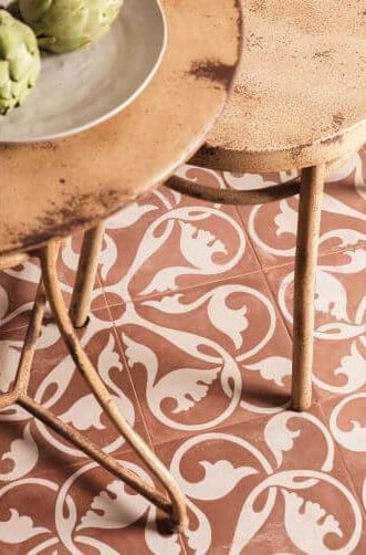 MODE_PATTERNED_CERAMIC_TILES_CLARET. Image shows red and cream patterned tile on floor with chairs