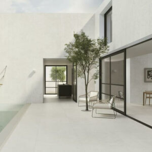 Abode white limestone porcelain tile. Image shows white limestone porcelain tile to indoor pool area.