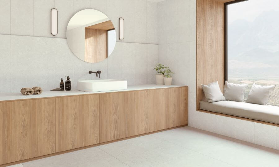 ABODE-WHITE-LIMESTONE-PORCELAIN-TILE-BATHROOM. Image shows white limestone porcelain tile in bathroom with window seat
