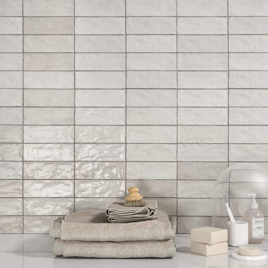 ADORE-WHITE-CERAMIC-SPANISH-TILE. Image shows white ceramic Spanish tile to wall with towels and soap