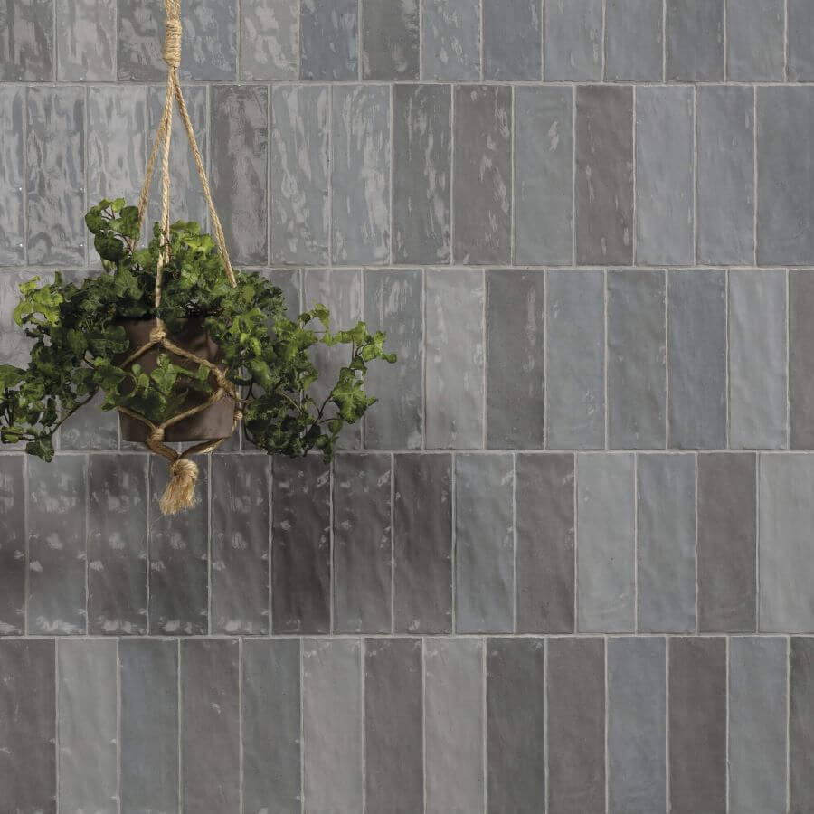 ADORE_DOVE_CERAMIC_SPANISH_TILE. Image shows grey ceramic Spanish tile to wall with hanging green plant in plant holder