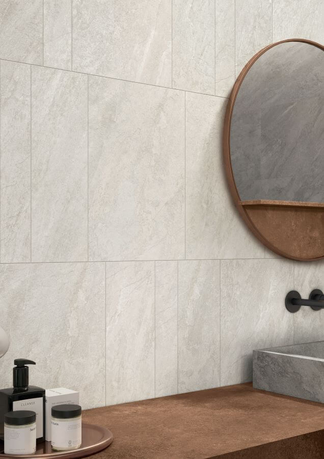 ALPINE-CHAMPAGNE-QUARTZ-EFFECT-PORCELAIN-TILE. Image shows white quartz effect porcelain tile on bathroom wall with mirror