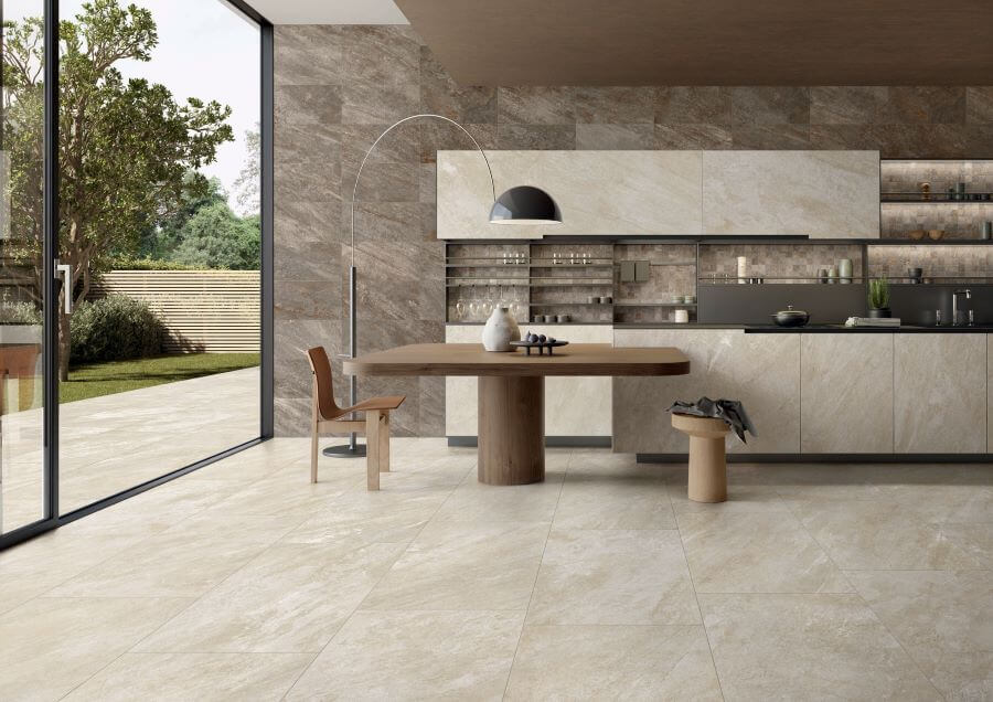 ALPINE-DESERT-QUARTZ-EFFECT-PORCELAIN-TILE. Image shows sand quartz effect porcelain tile in kitchen and onto patio with table and chairs