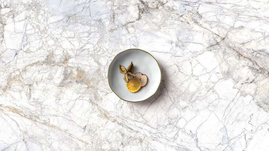 BELLEZA-WHITE-MARBLE-EFFECT-TILE-CLOSEUP. Image shows white marble effect tile with plate of food on top