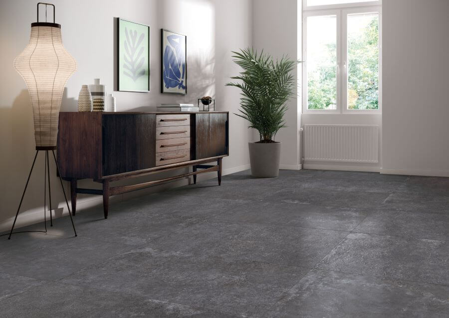 DOCKLANDS-CHARCOAL-CEMENT-PORCELAIN-TILE. Image shows charcoal cement porcelain tile on lounge floor