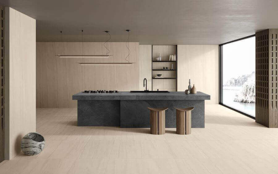 Ethos Sand. Image shows sand stone look porcelain tile on kitchen floor with large grey stone island unit
