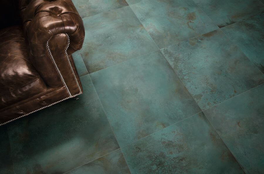 FORGE-MINT-PORCELAIN-METALLIC-BATHROOM-TILES. Image shows green metallic tiles in lounge with dark brown sofa