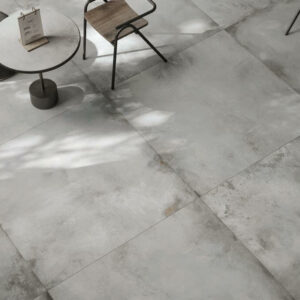 FORGE-TITANIUM-PORCELAIN-METALLIC-TILES-FLOOR. Image shows white porcelain metallic tiles in cafe with table and chair