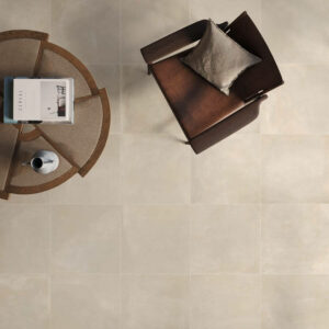 TONE-ECRU-120X60-NEW-PORCELAIN-TILES. Image shows ecru porcelain tiles in a lounge with a table and chair