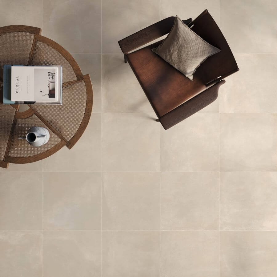 TONE-ECRU-120X60-NEW-PORCELAIN-TILES. Image shows ecru porcelain tiles in a lounge with a table and chair