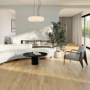 SERENITY-HONEY-WOOD-PLANK-PORCELAIN-TILE. Image shows honey wood plank porcelain tiles in lounge with sofa and chair