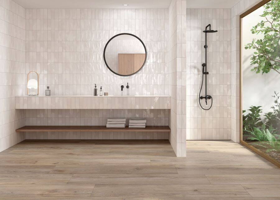 SERENITY-TAUPE-WOOD-PLANK-PORCELAIN-TILE. Image shows taupe wood plank porcelain tiles in bathroom with white tiles on wall