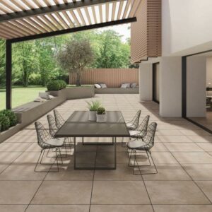 STRIDE-ARENA-20MM-CONCRETE-PORCELAIN-TILE. Image shows sand 20mm concrete porcelain tile on patio with dining table and chairs