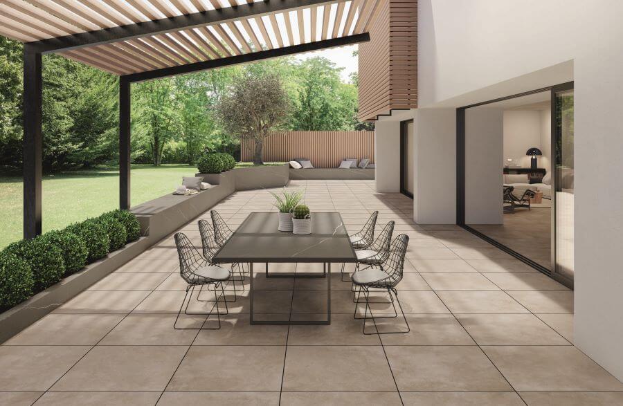 STRIDE-ARENA-20MM-CONCRETE-PORCELAIN-TILE. Image shows sand 20mm concrete porcelain tile on patio with dining table and chairs