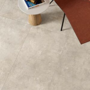 Image shows Minima porcelain concrete look tile in mist to wall with shelf and books