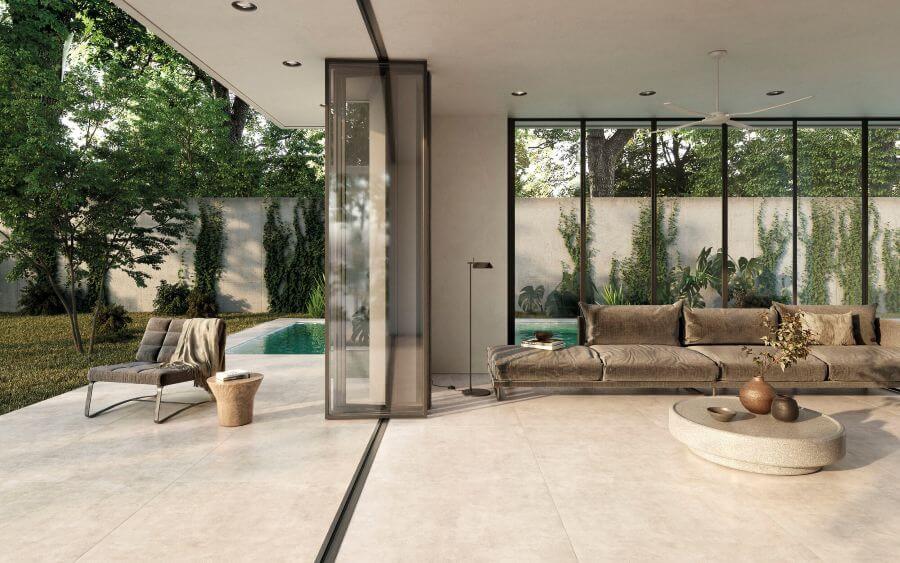 NEST-CONCRETE-EFFECT-TILE-SAND-1. Image shows sand concrete effect tile in lounge and out onto the patio