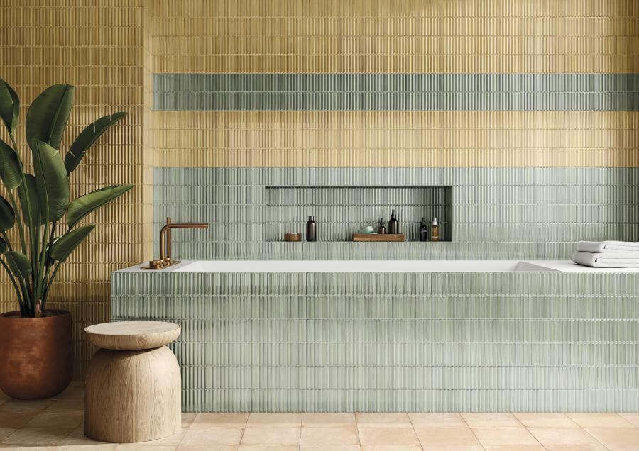 HUSH-CERAMIC-KIT-KAT-WALL-TILE-OLIVE. Image shows yellow kit kat wall tile around bath and on wall behind with green kit kat tile