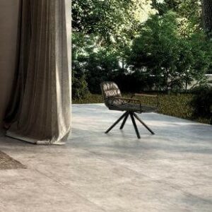 NEST-1000-X-1000-OUTDOOR-PORCELAIN-TILES-TAUPE. Image shows concrete effect tile in taupe and grey on outside patio
