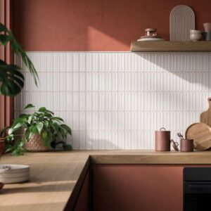ARC-PORCELAIN-WALL-FEATURE-TILES-AMBER-WHITE. Image shows white porcelain wall feature tiles in kitchen with red wall and units