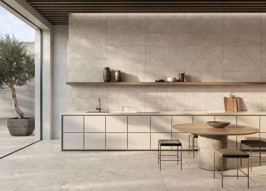NATURE-STONE-EFFECT-FLOORING-BONE. Image shows stone effect flooring in a light light tan colour with a dining table and chairs and kitchen units