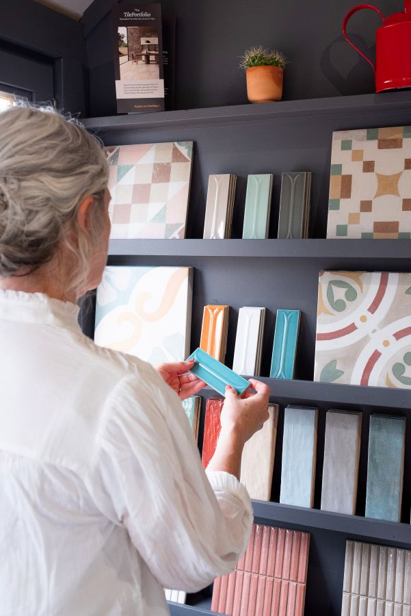 Showroom 7. Image shows lady looking at small colourful tiles