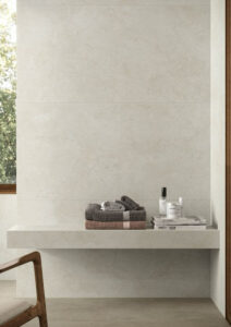 Joy large format porcelain tiles, image shows silver stone effect tiles used on a bathroom wall.
