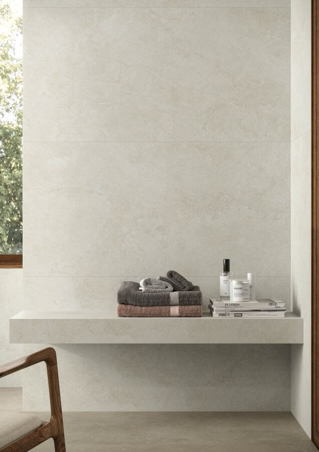 Joy large format porcelain tiles, image shows silver stone effect tiles used on a bathroom wall.
