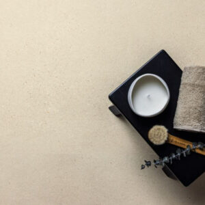 Close up of Speckle stone-effect porcelain tile in beige colour on the floor of a bathroom.