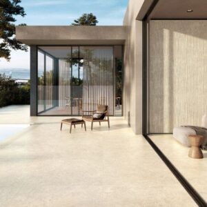 Seamless transition from patio to interior using 20mm Warm Taupe Cherish outdoor porcelain tiles and matching indoor stone-effect flooring.