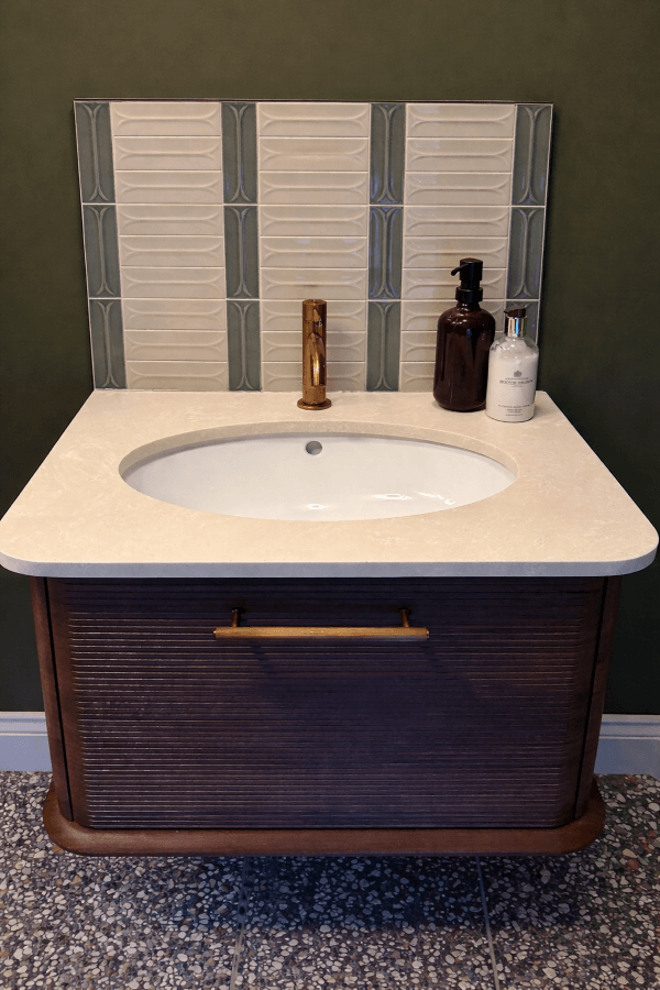 3D-effect Arc Taupe and Grey porcelain feature wall tiles, showcasing the textured curved pattern and soft neutral tones in a modern bathroom.