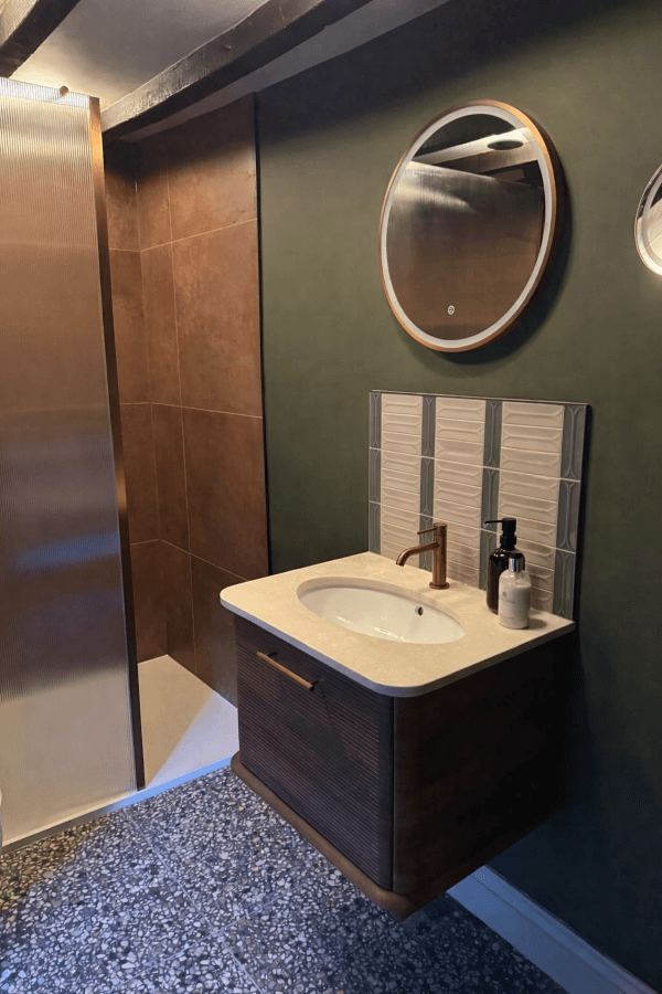Modern bathroom feature wall using Arc Taupe and Grey porcelain tiles, showing the 3D curved texture and contemporary neutral colour palette.