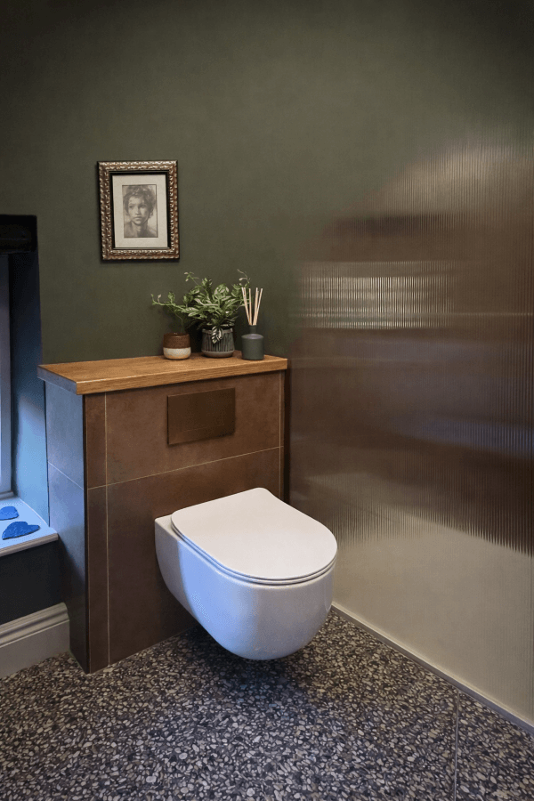 Contemporary bathroom floor featuring Misto Terrazzo-effect porcelain tiles in Notte, showing the dark charcoal base with multi-coloured stone fragments.