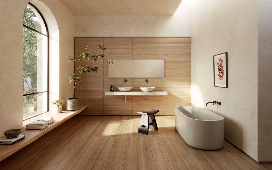 A bathroom with wood effect porcelain tiles and a large stand alone bath with vanity unit