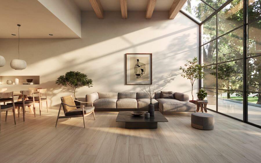 A lounge with wood effect porcelain tiles to the floor and a large sofa